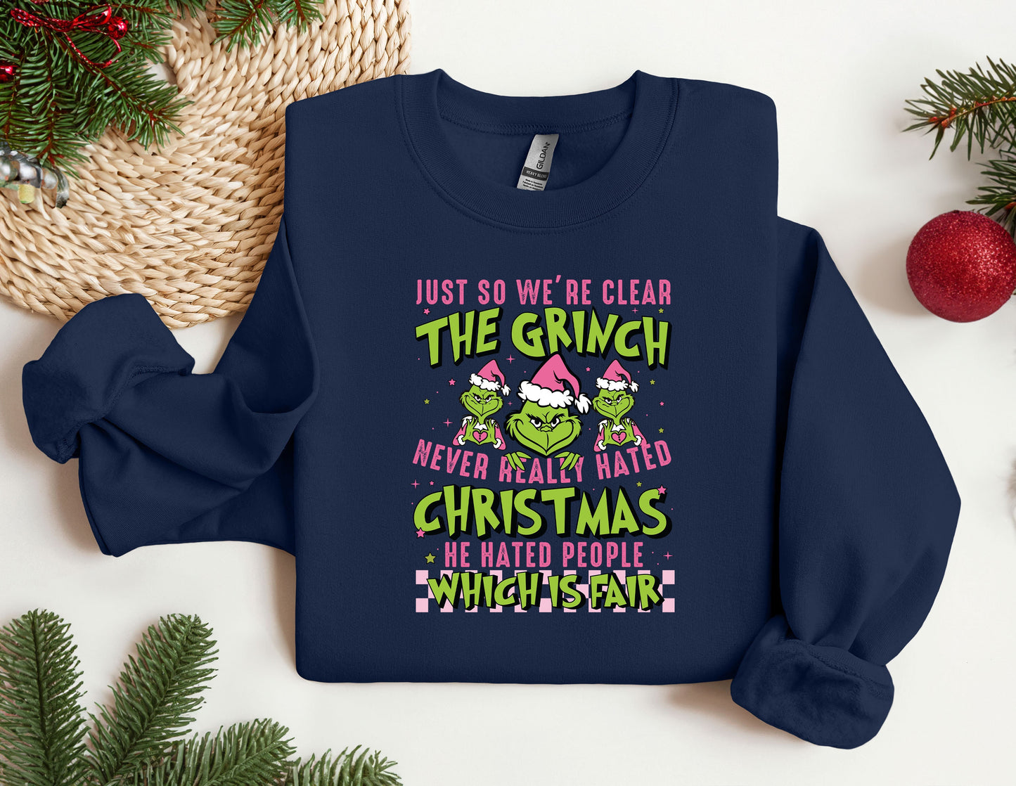 a christmas sweater with the grin saying just so we're clear the grin never