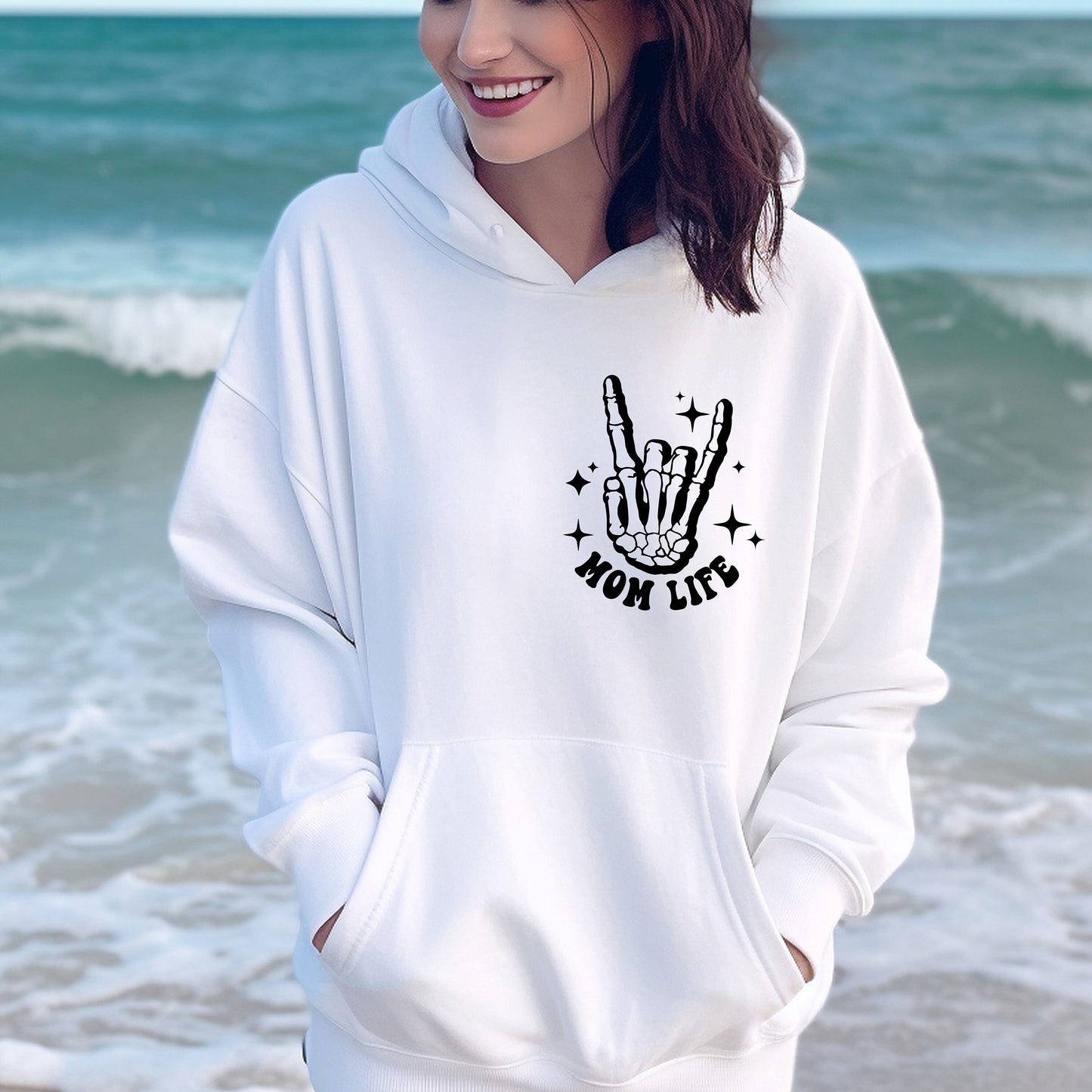 a woman wearing a white hoodie with a peace sign on it