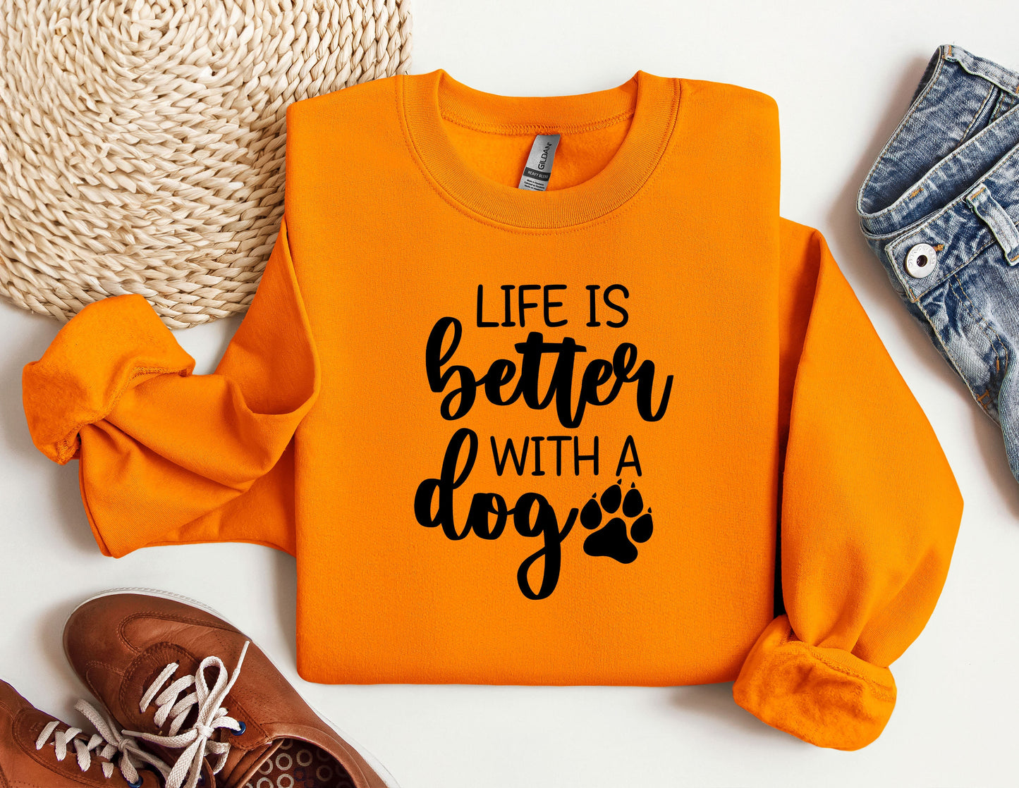an orange sweatshirt with a dog's paw on it