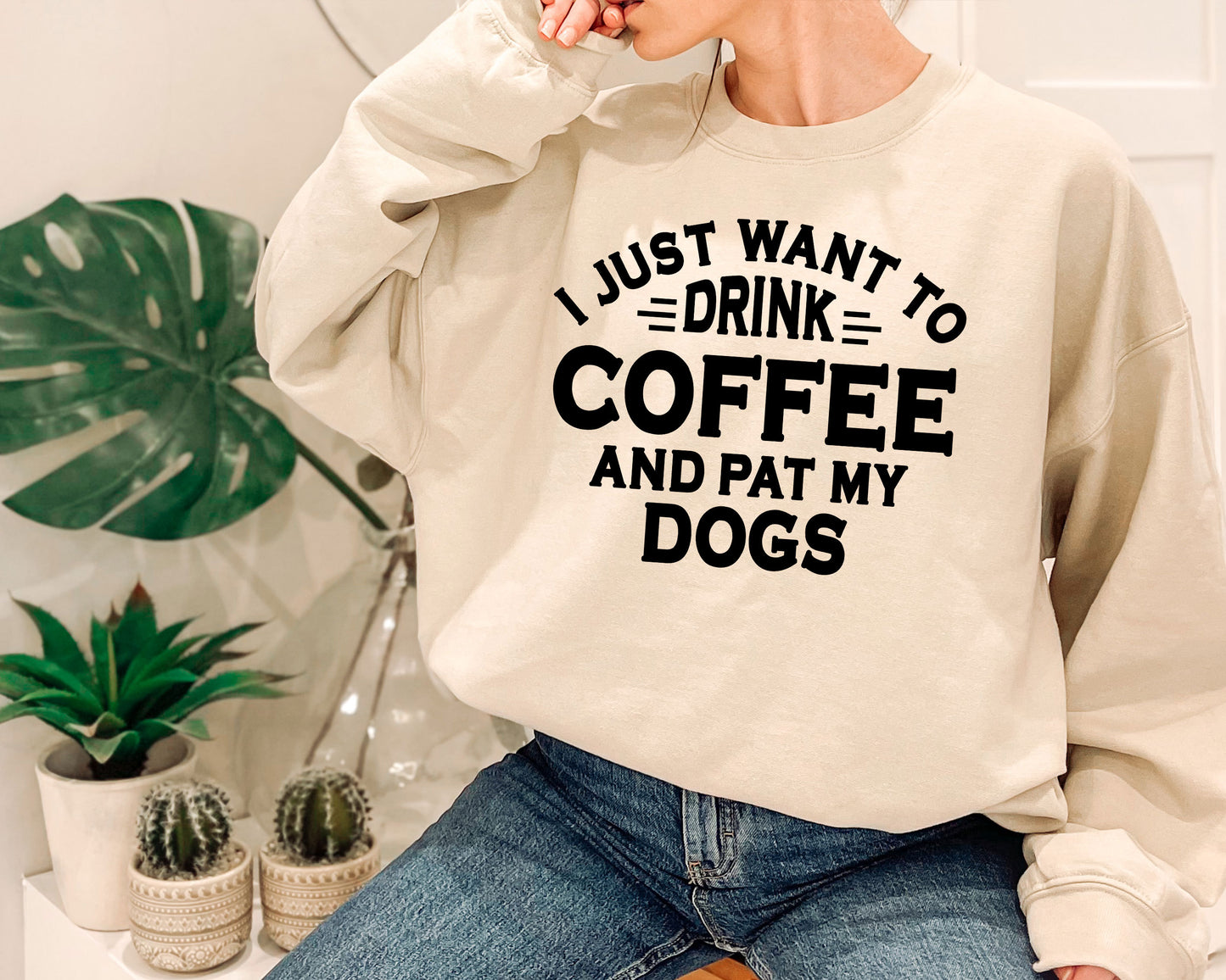 a woman wearing a sweatshirt that says i just want to drink coffee and pat my