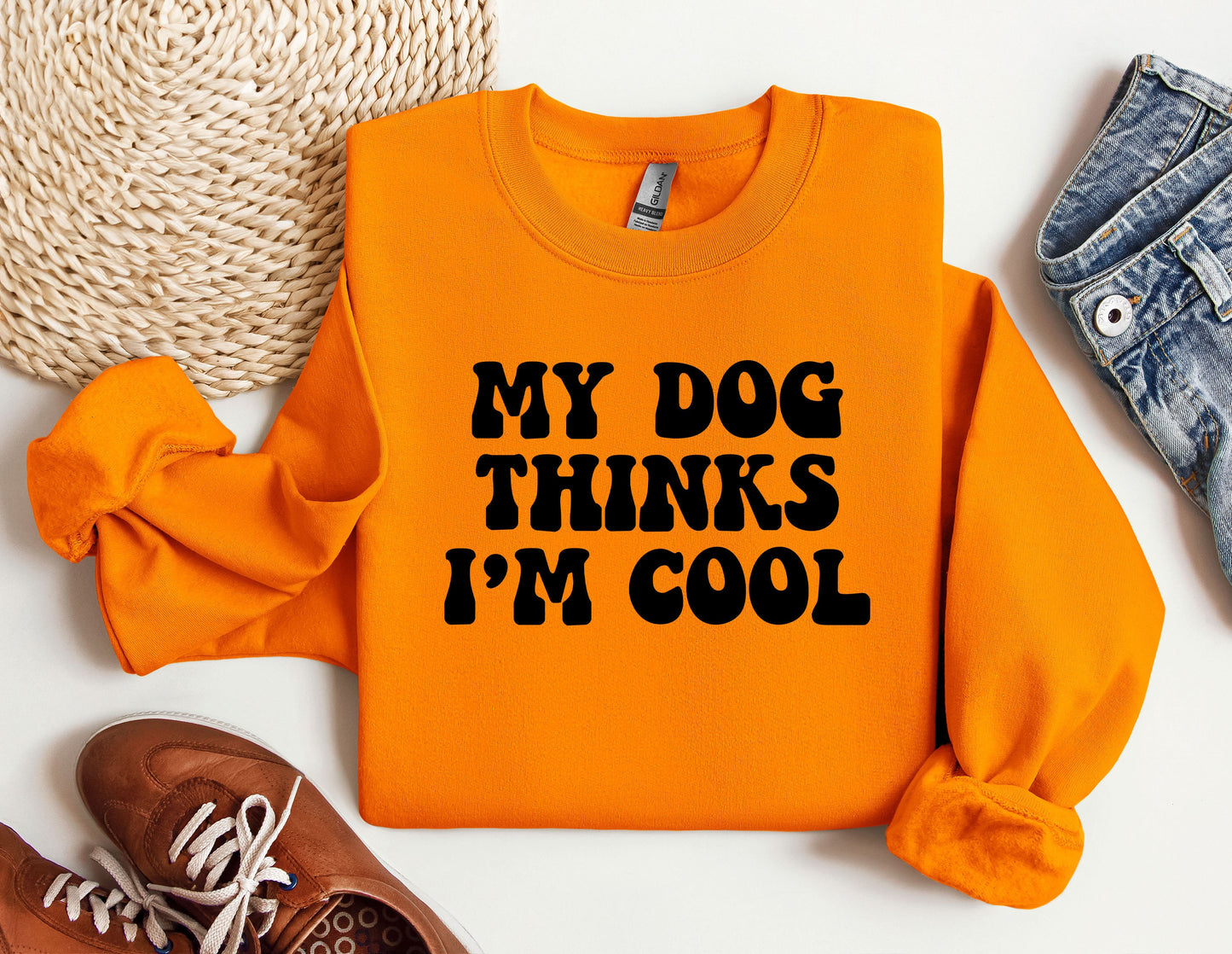 an orange sweatshirt that says, my dog thinks i'm cool