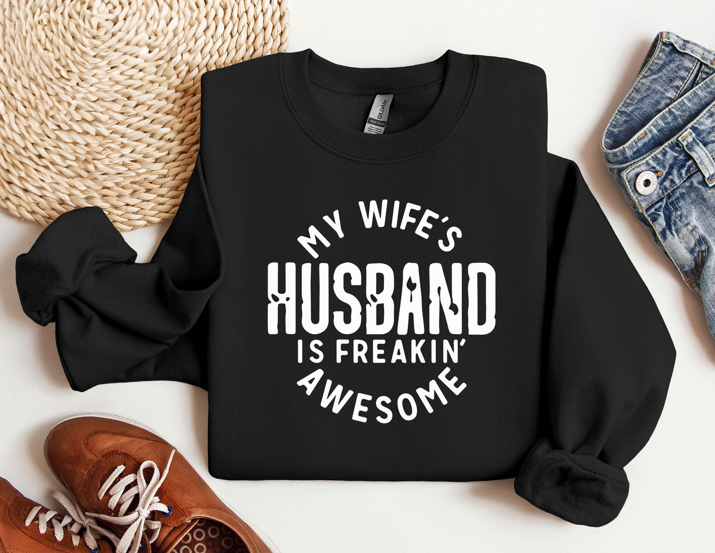 a black sweatshirt that says, my wife's husband is freakin'awesome