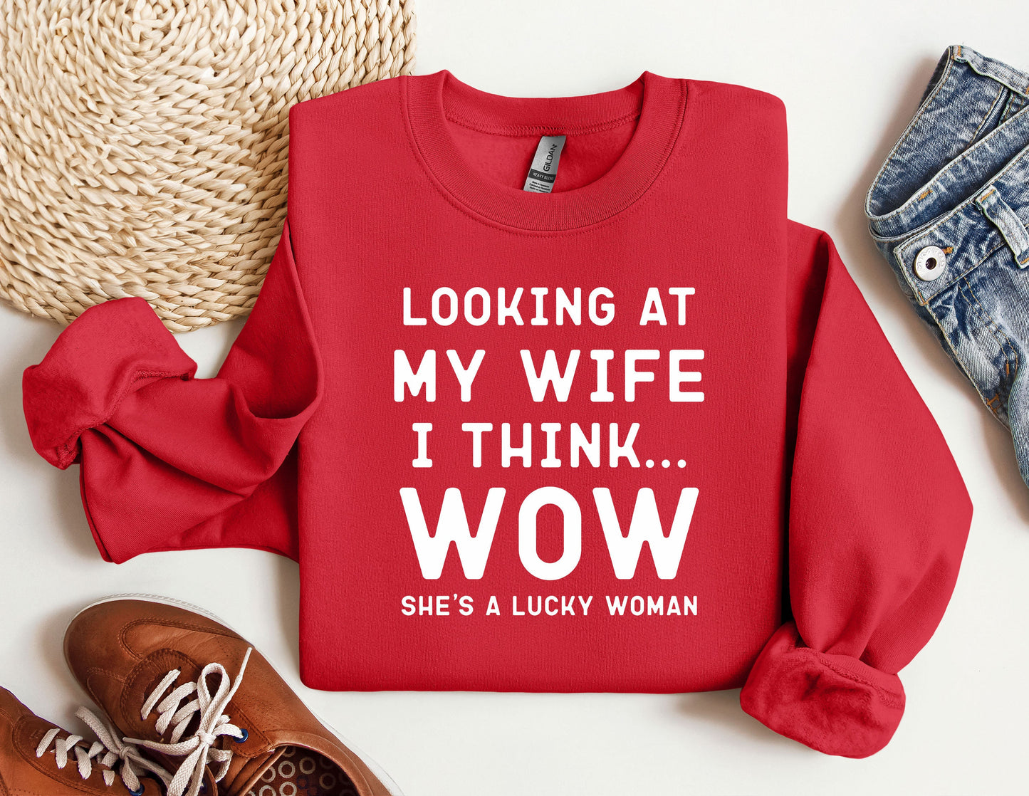 a red sweater that says looking at my wife i think she's a lucky
