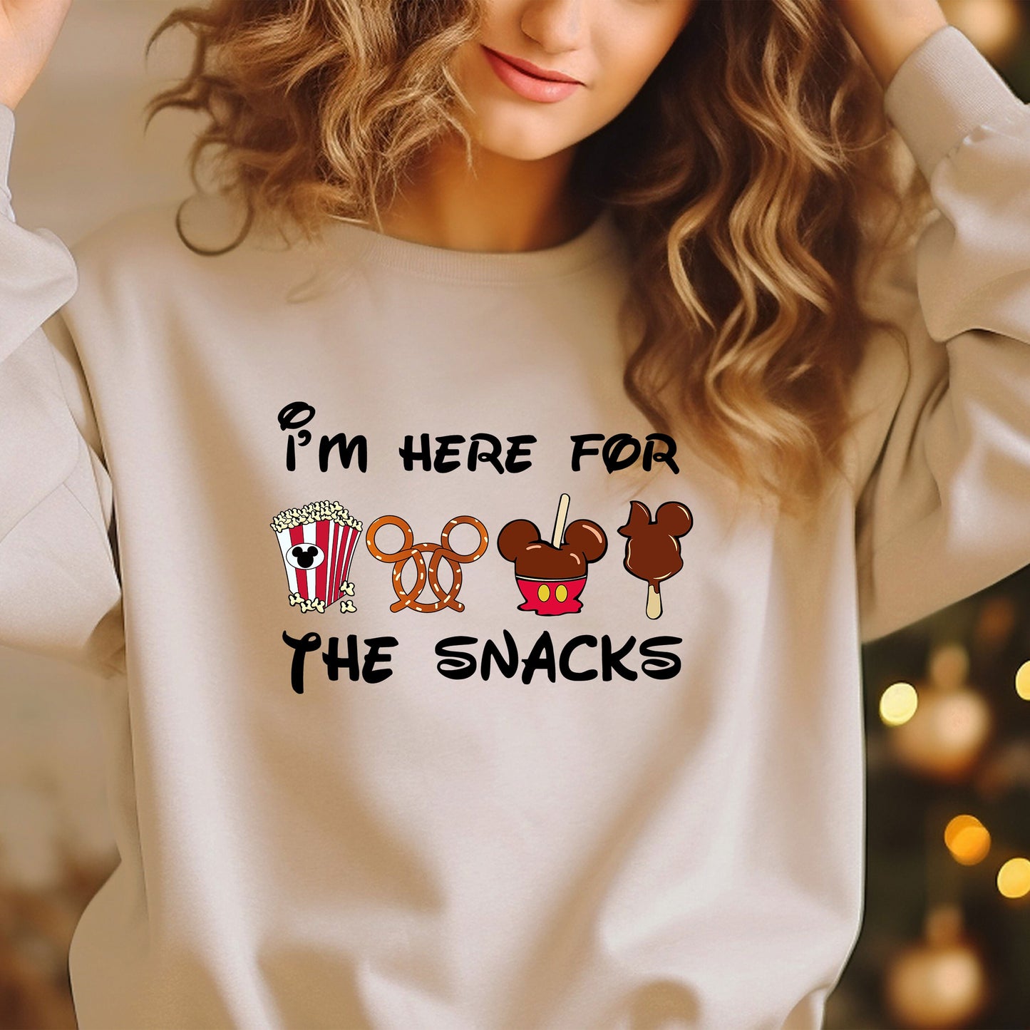 a woman wearing a sweatshirt that says i'm here for the snacks