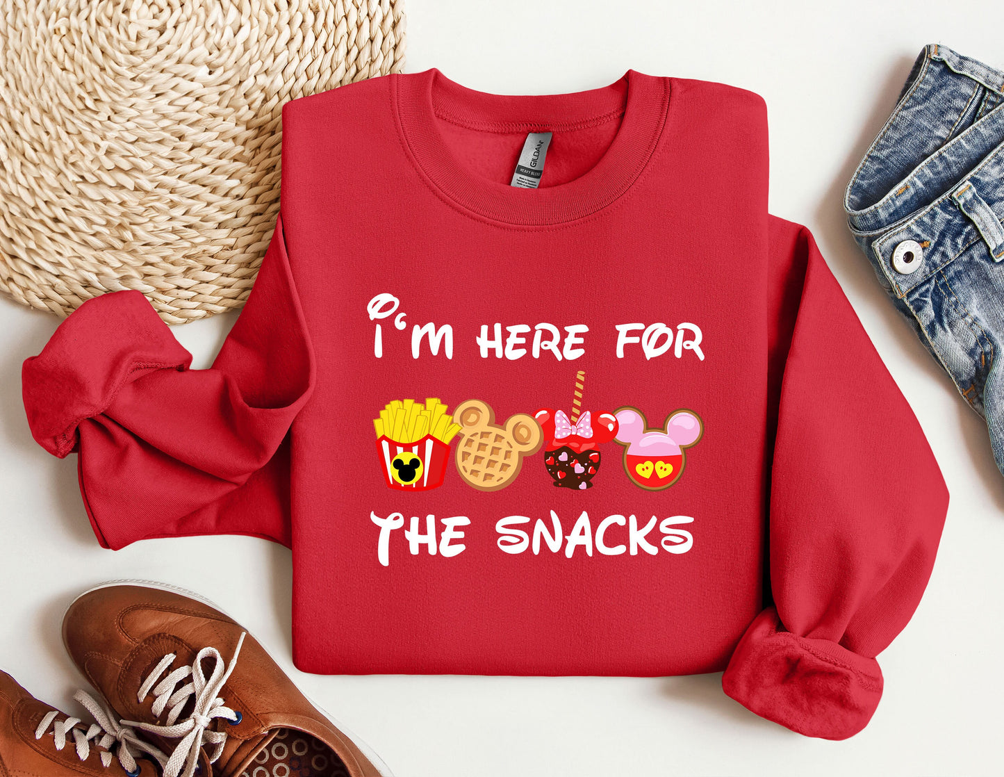 a red sweatshirt with the words i'm here for the snacks printed on it