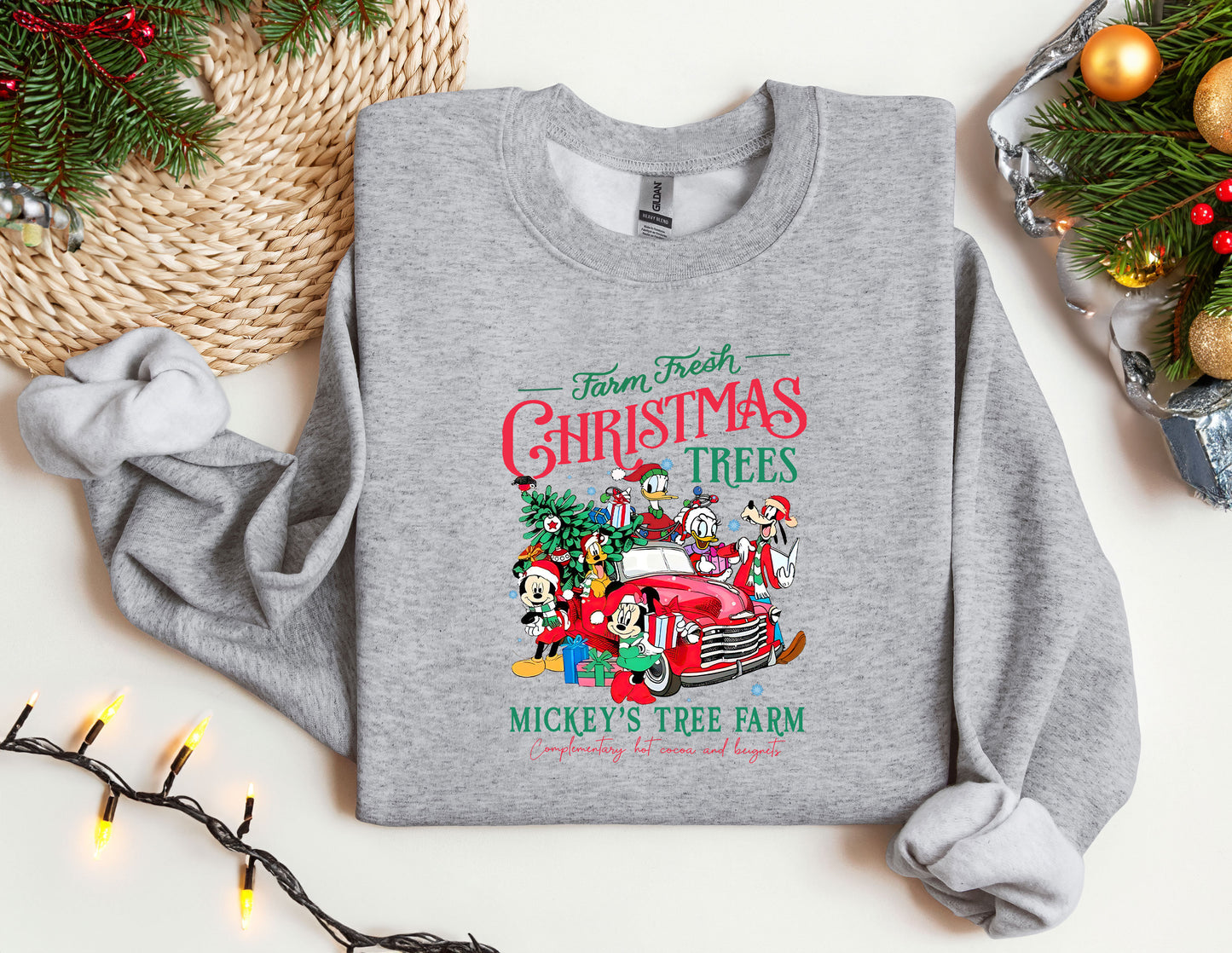 a gray sweatshirt with christmas trees and mickey mouse's tree farm on it