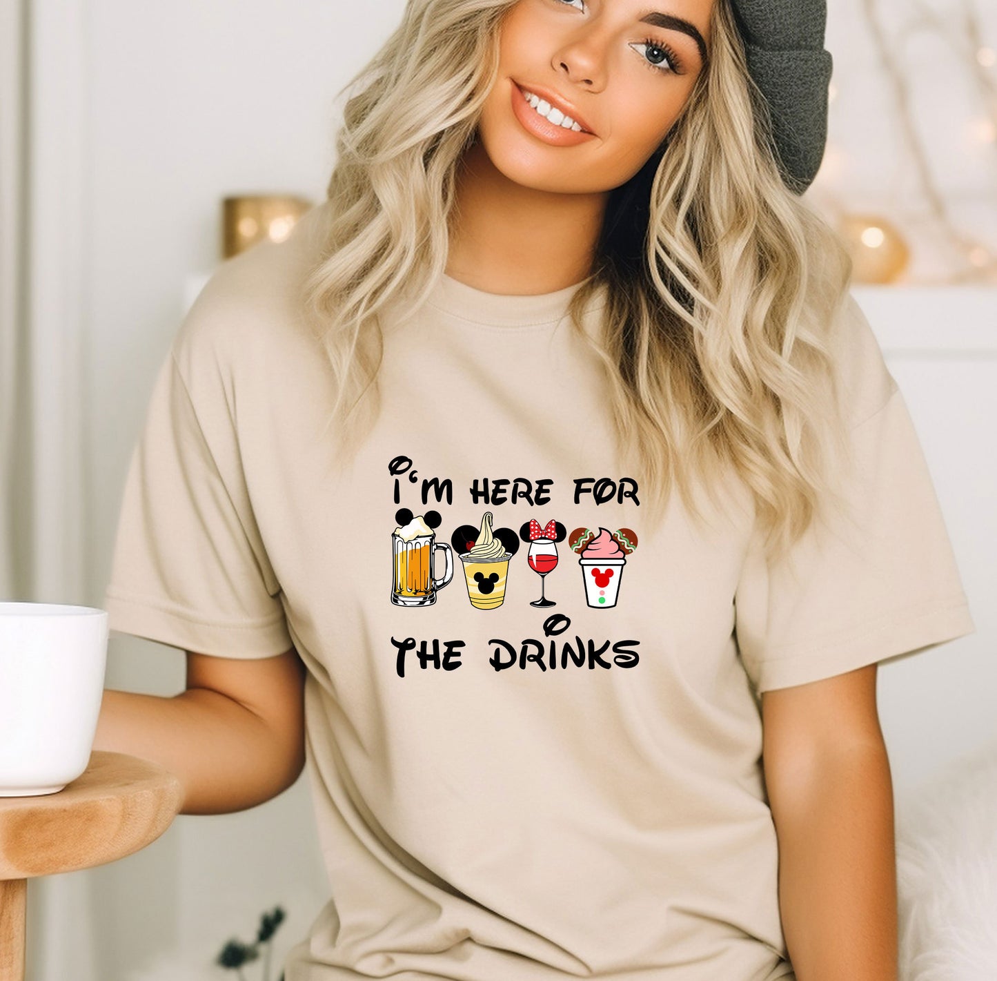 a woman wearing a t - shirt that says i'm here for the drinks