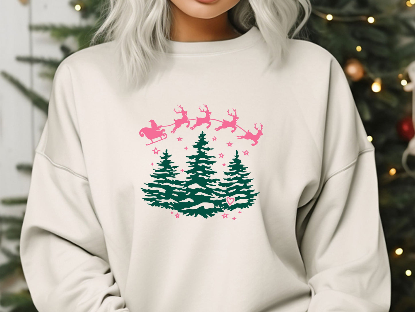 a woman wearing a sweatshirt with a christmas tree and santa's sleigh