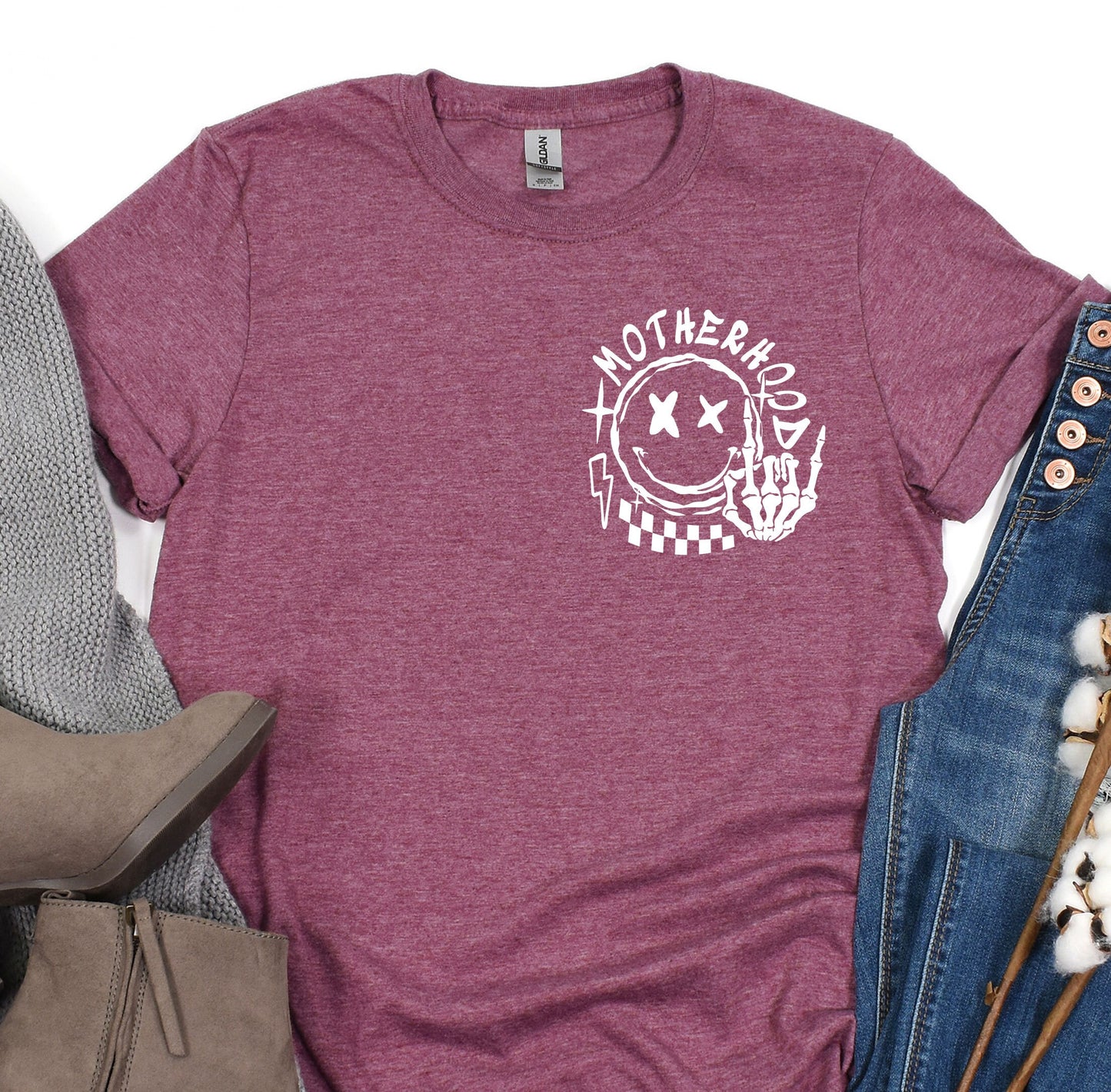 a women's t - shirt with the words motherhood printed on it