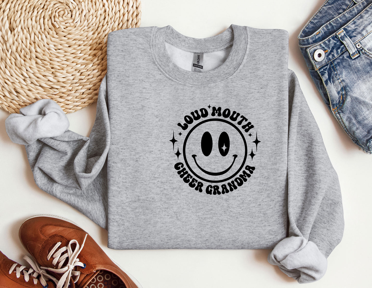 a gray sweatshirt with a smiley face on it