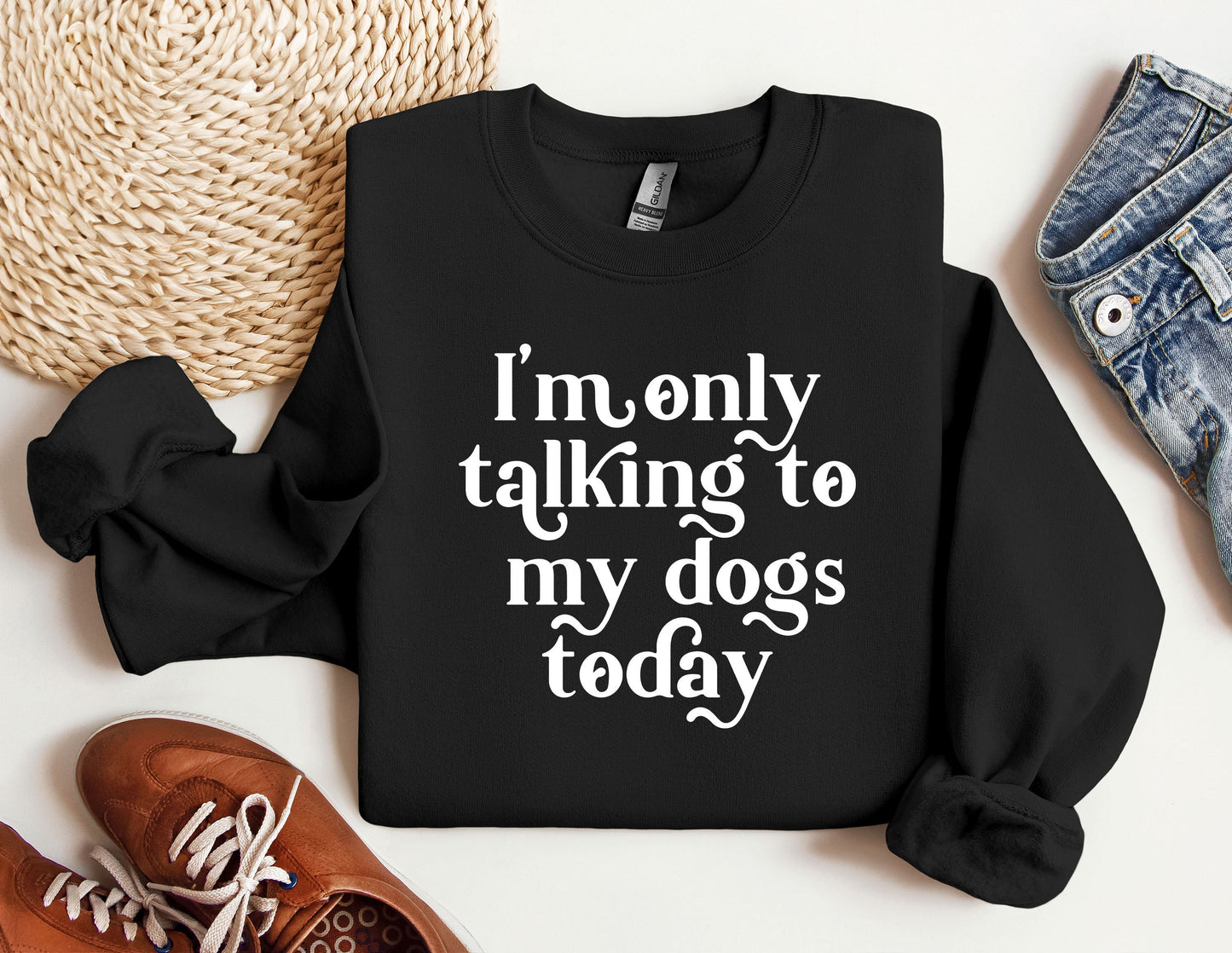 a black sweatshirt with white writing that says i'm only talking to my dogs