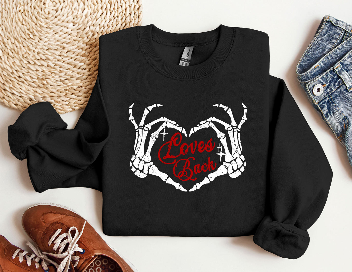 a black sweatshirt with the words love is back on it next to a pair of