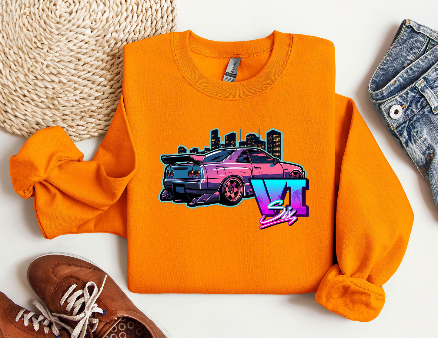 an orange shirt with a pink car on it