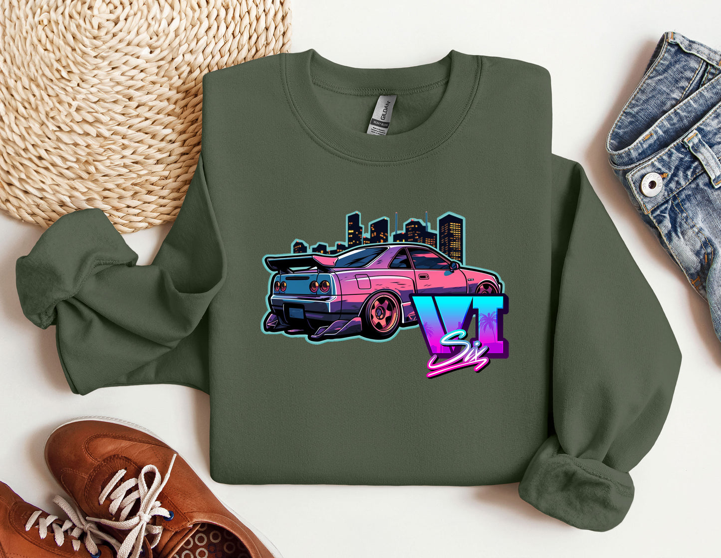 a green sweatshirt with a pink car on it