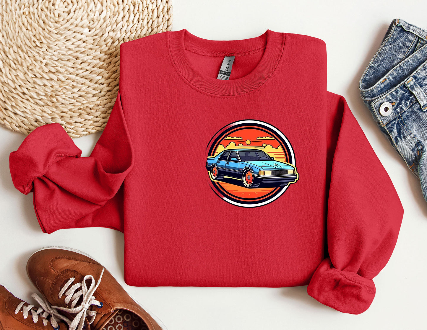 a red sweatshirt with a picture of a car on it