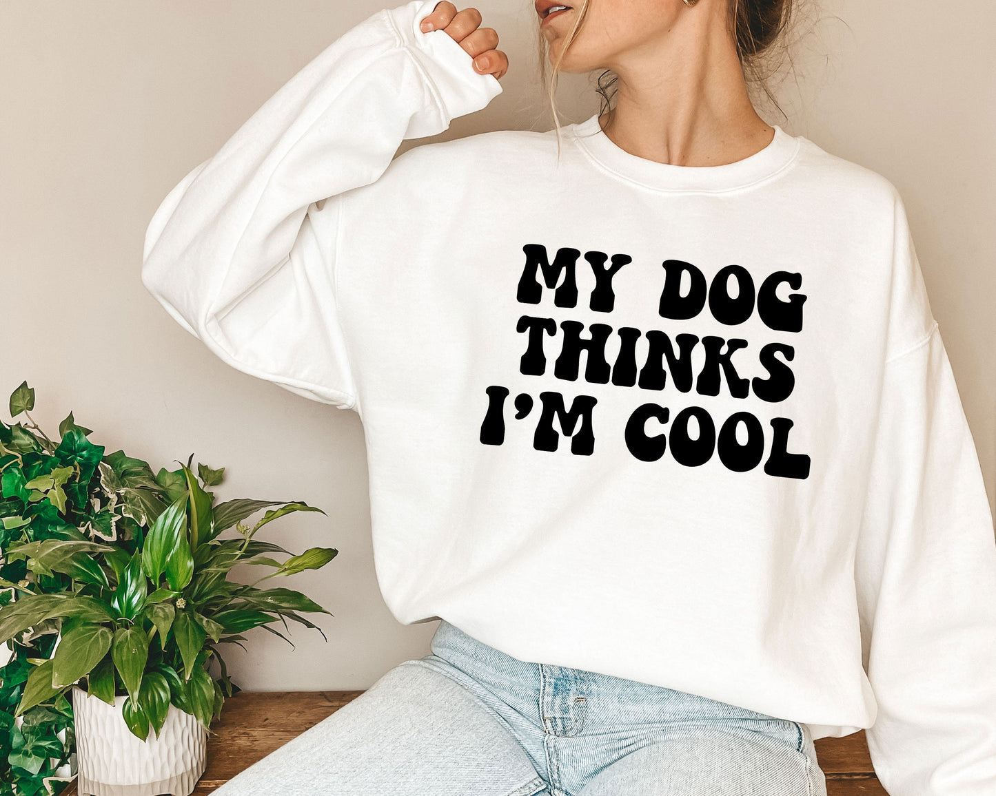 a woman wearing a sweatshirt that says, my dog thinks i'm cool
