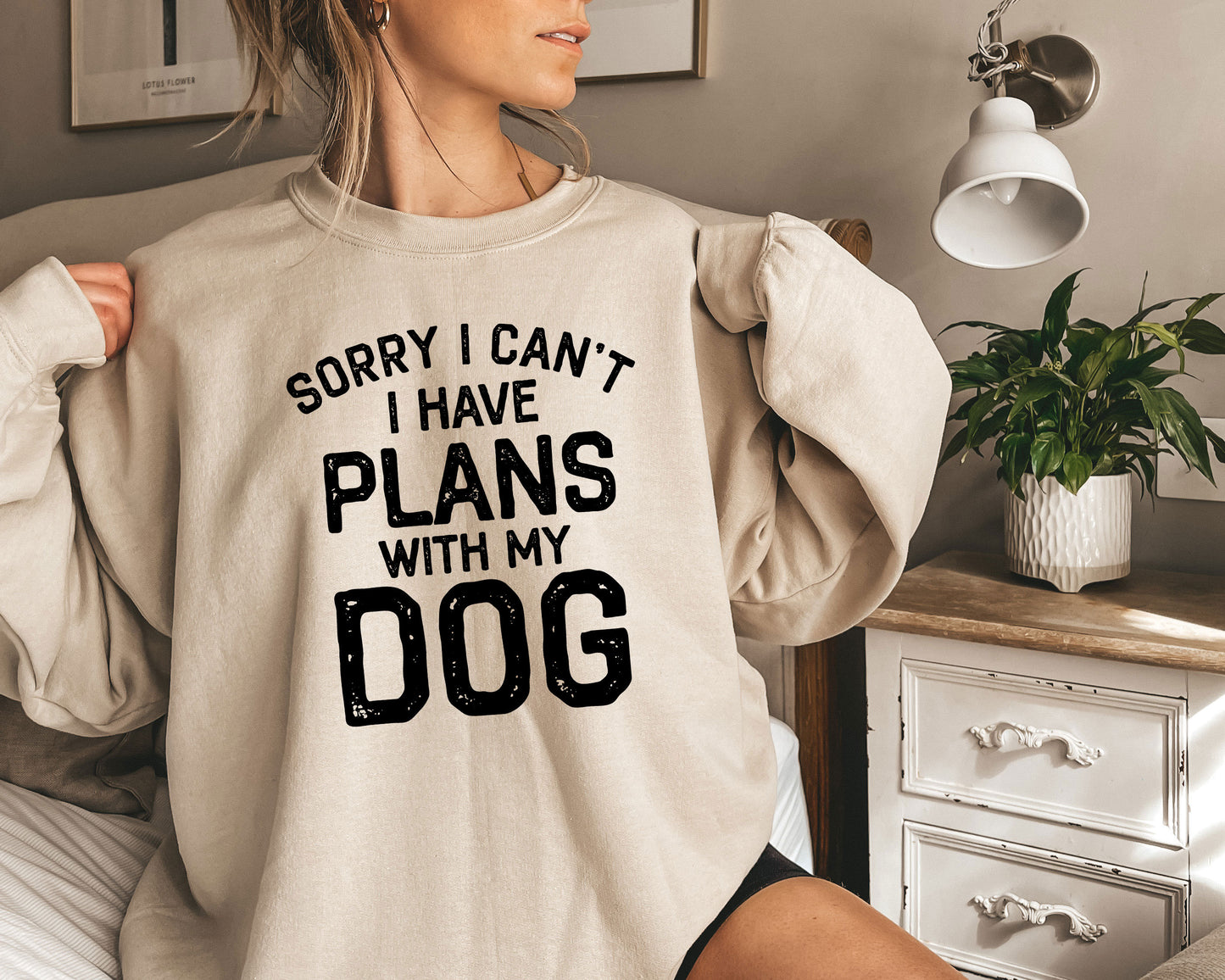 a woman wearing a sweatshirt that says sorry i can't i have plans with