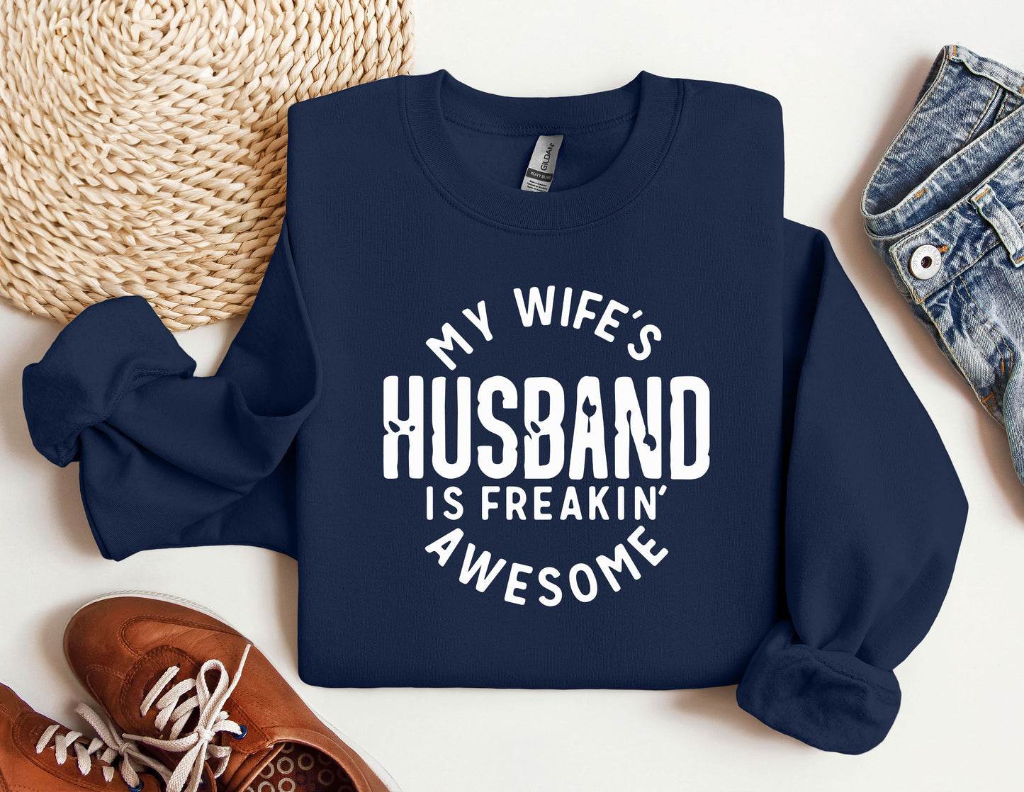 a sweatshirt that says, my wife's husband is freakin'awesome