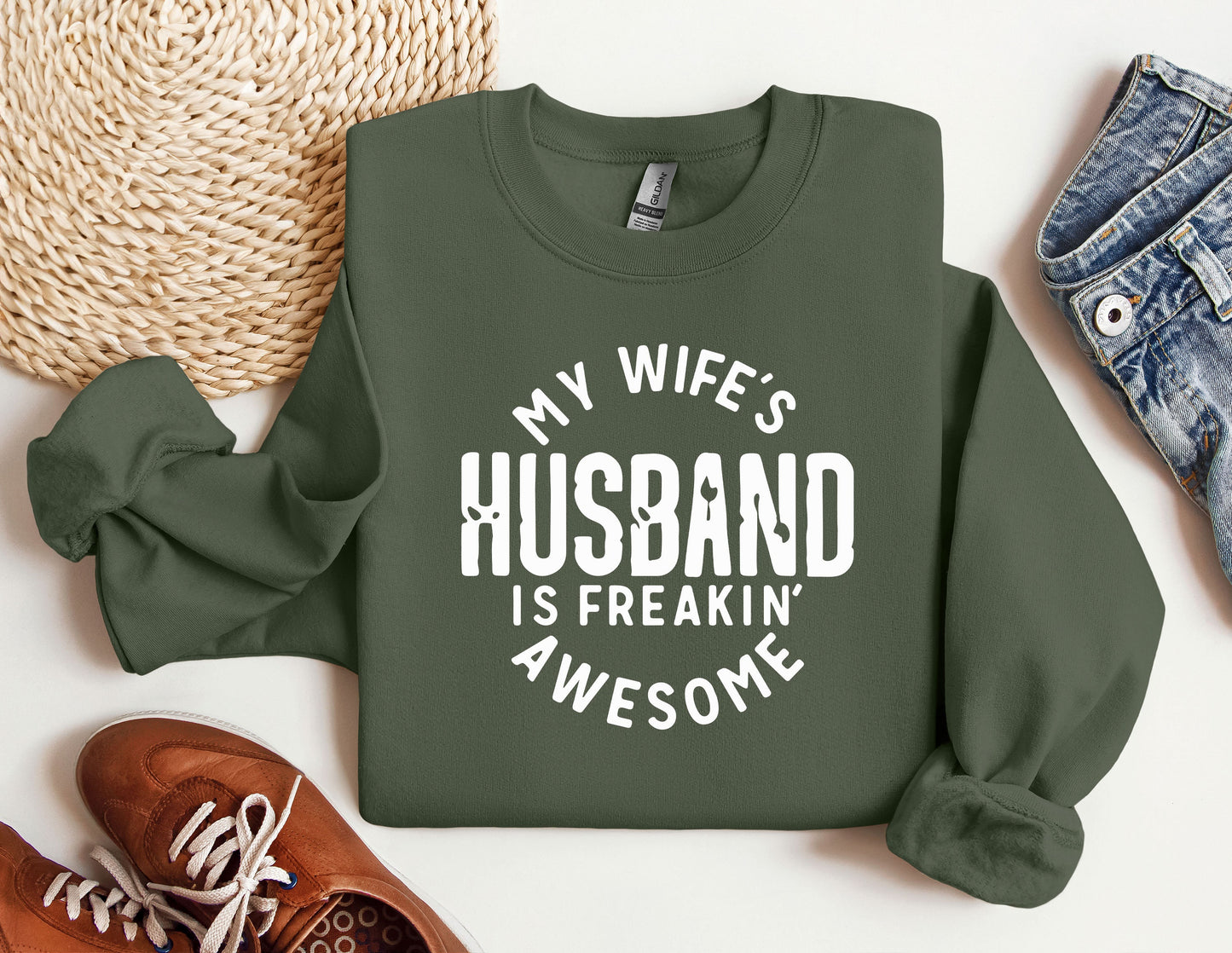 a sweatshirt that says, my wife's husband is freakin'awesome