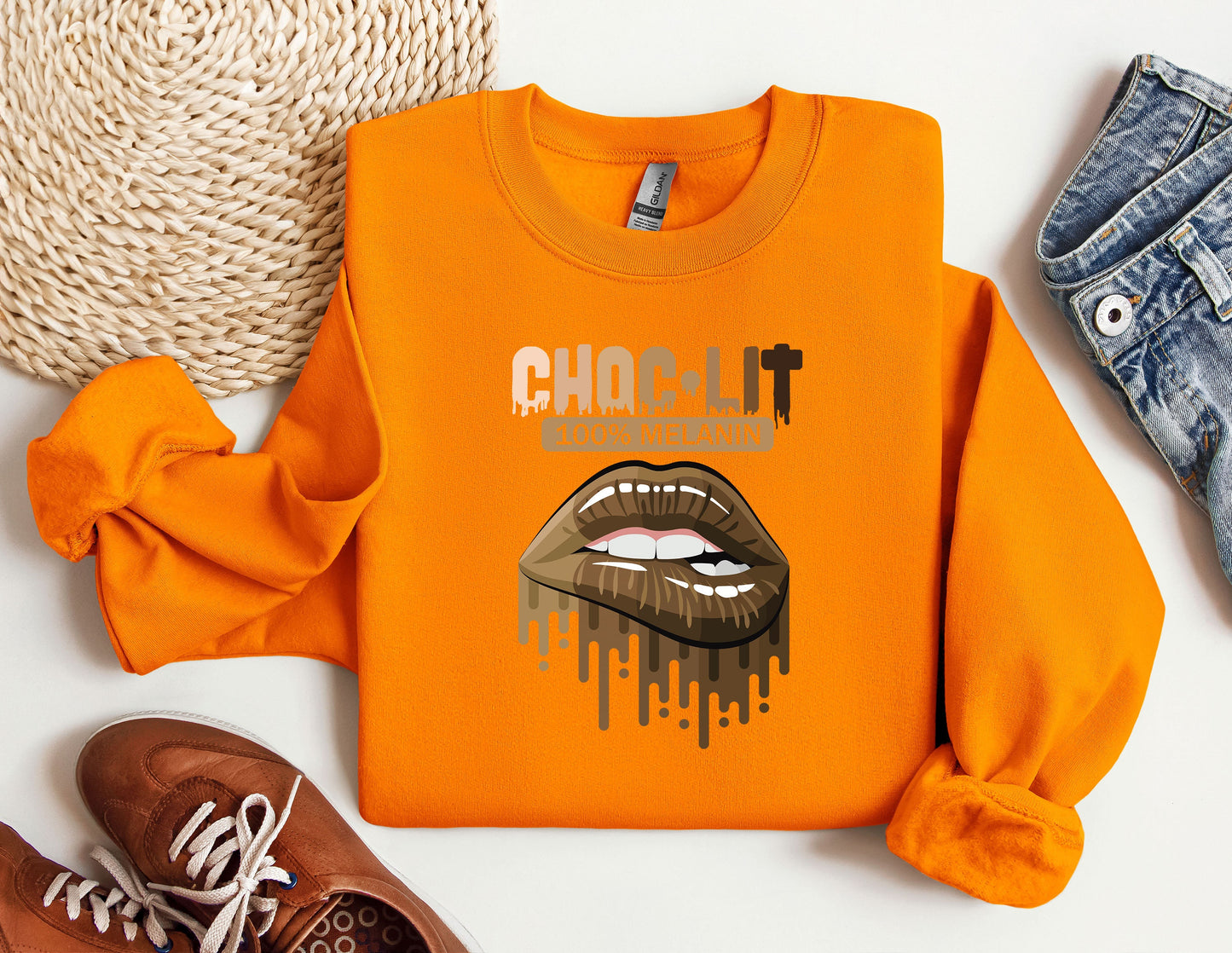 a pair of shoes and an orange shirt with a picture of a woman's