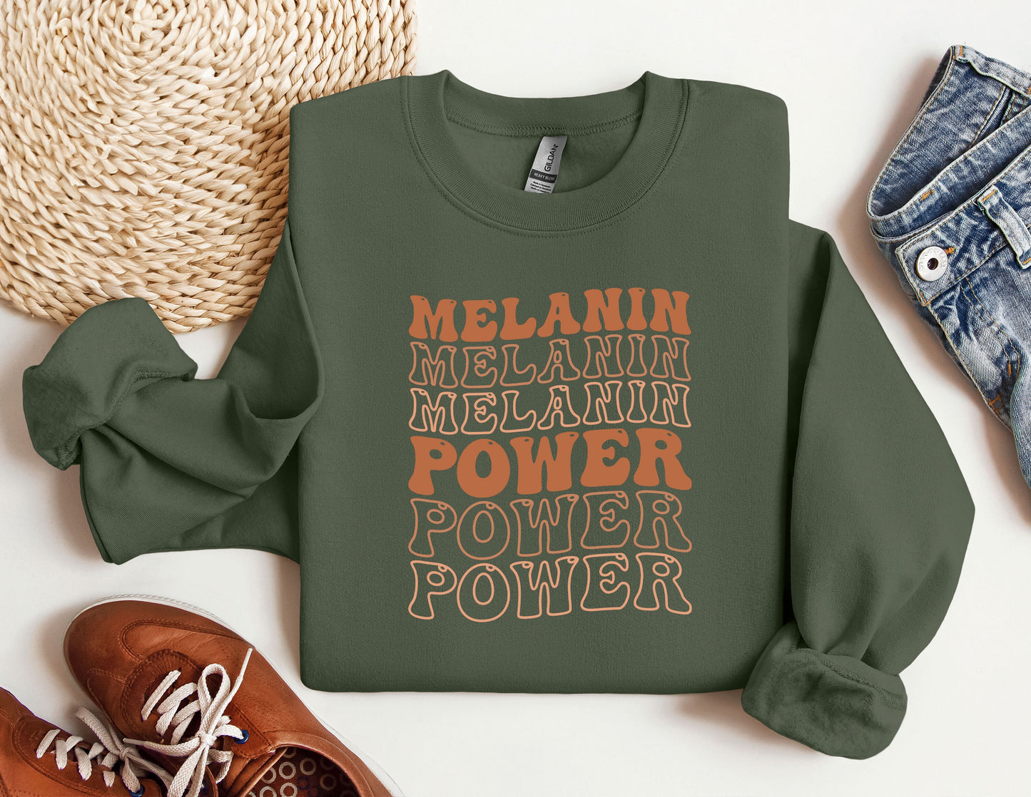 a green sweatshirt with the words melanin, melanin, melani
