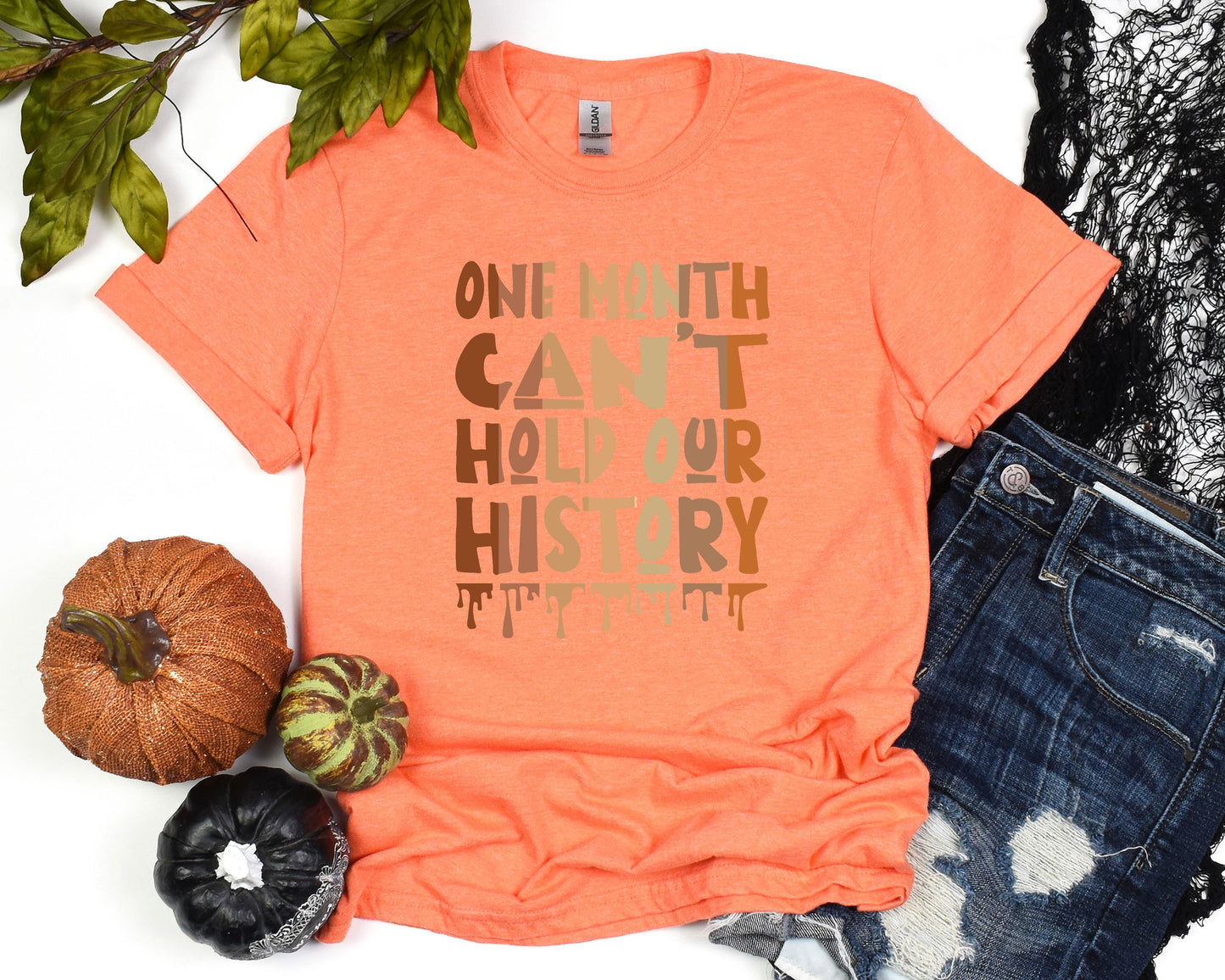 a t - shirt that says, one with can't hold our history