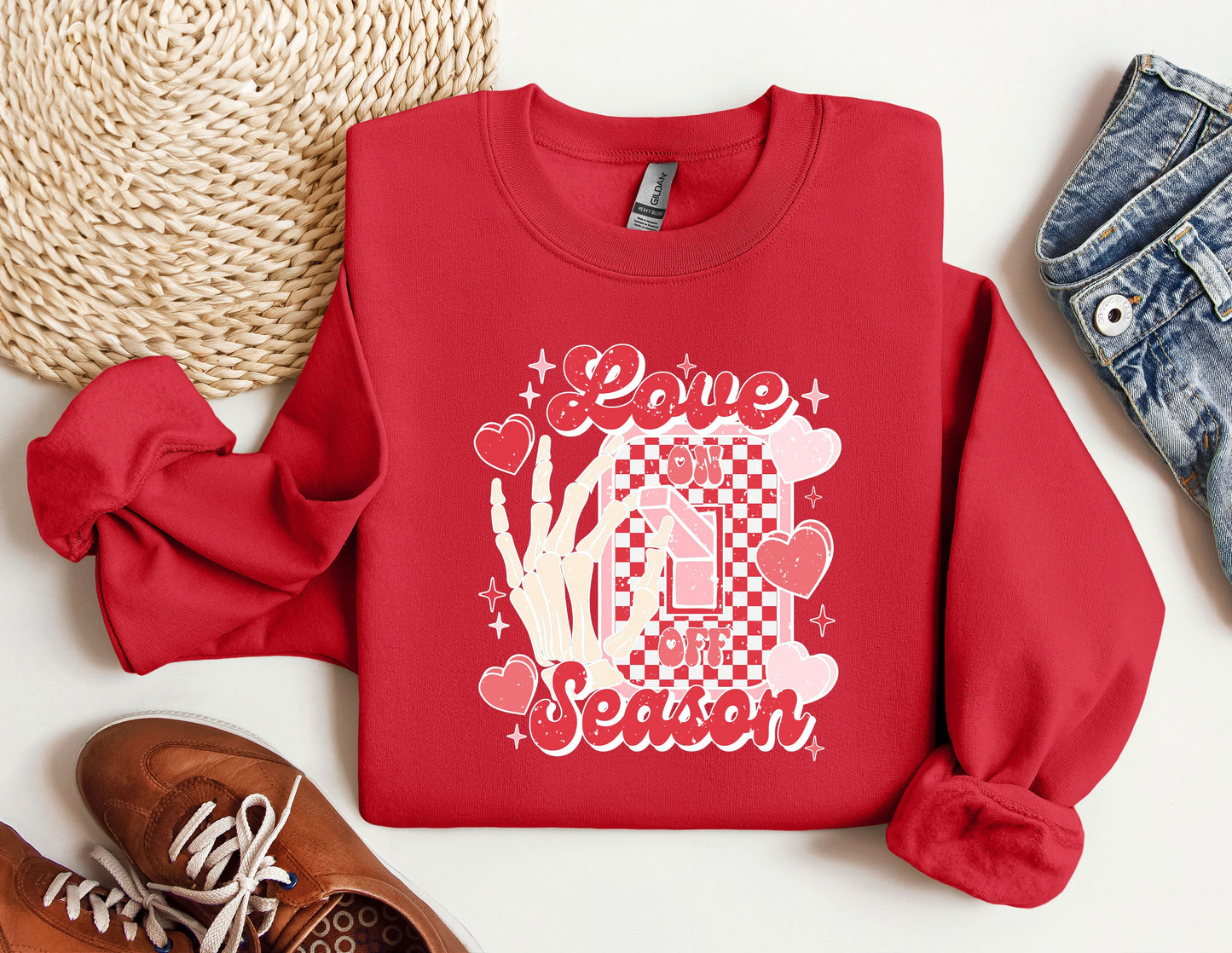 a red sweatshirt with a picture of a woman's hand and hearts on it