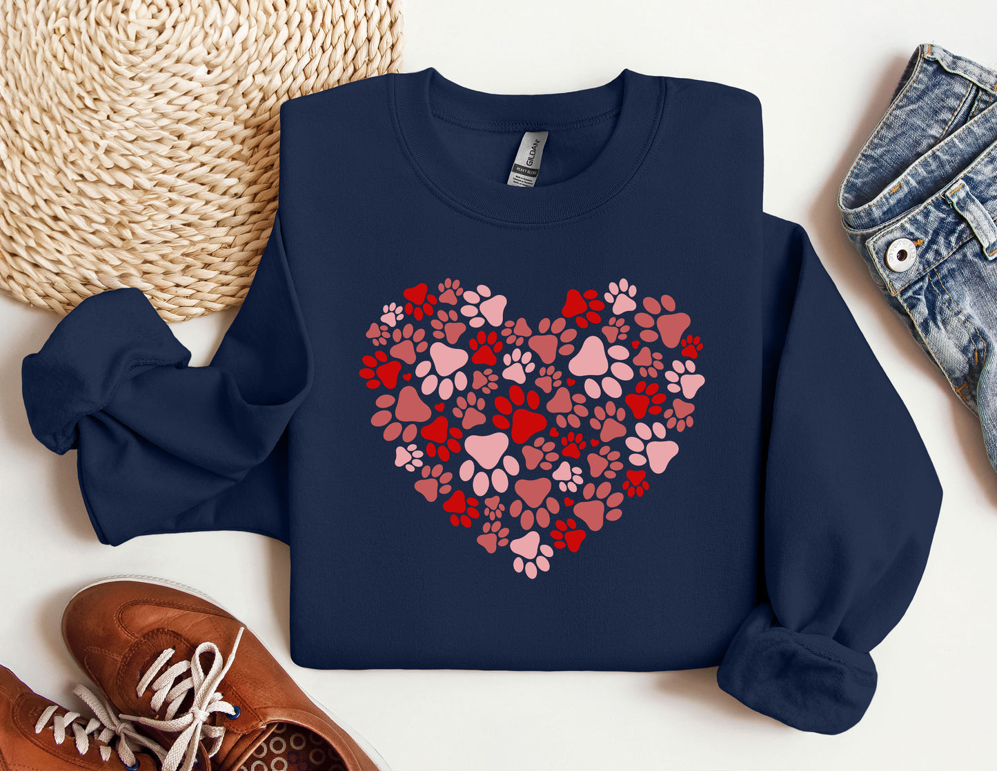 a blue sweatshirt with a heart made out of paw prints