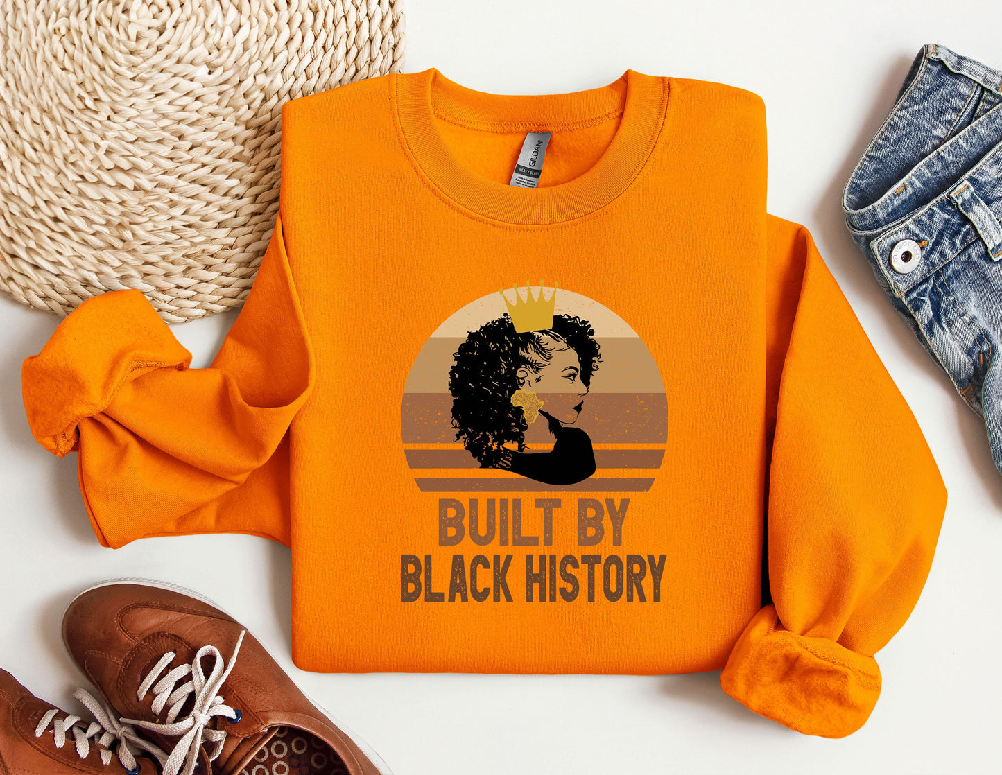 an orange shirt with a picture of a woman's face on it