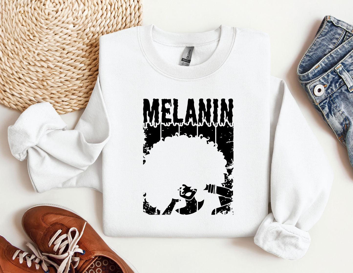 a white sweatshirt with a black graphic of a man's head