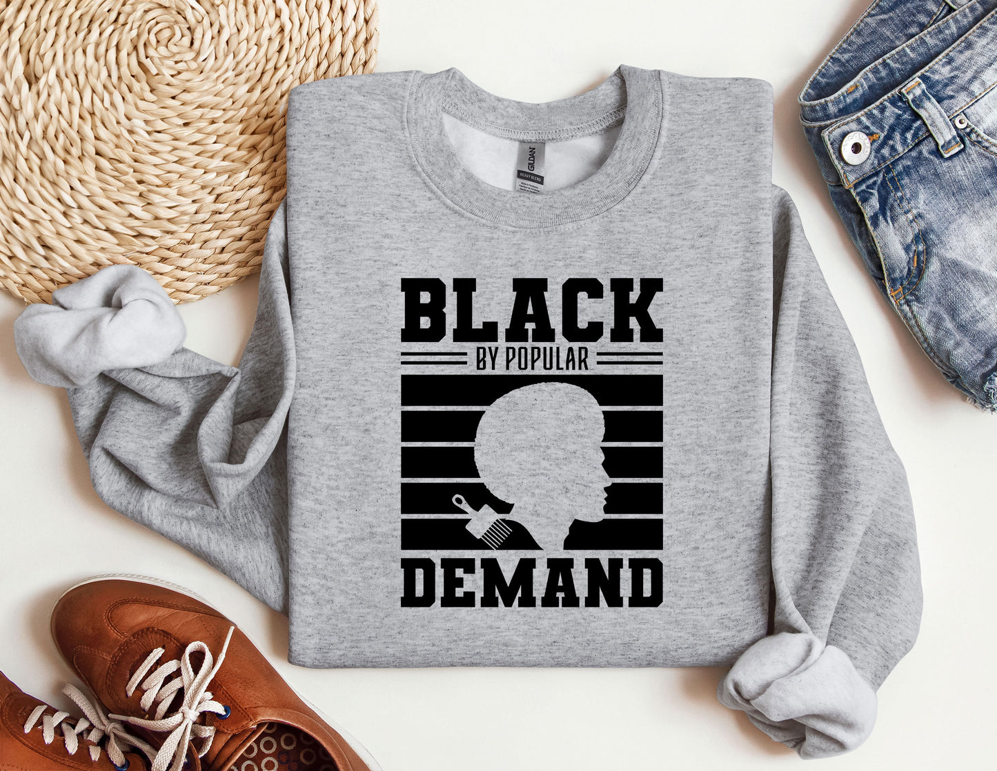 a gray sweatshirt with a picture of a man's face and the words black
