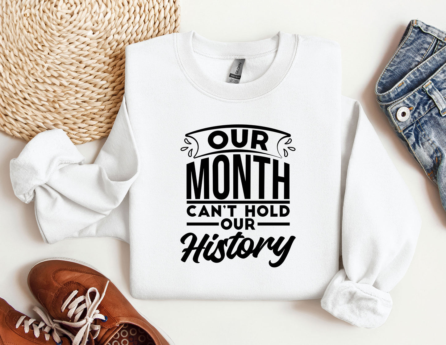 a white sweatshirt with the words our month can't hold our history on it