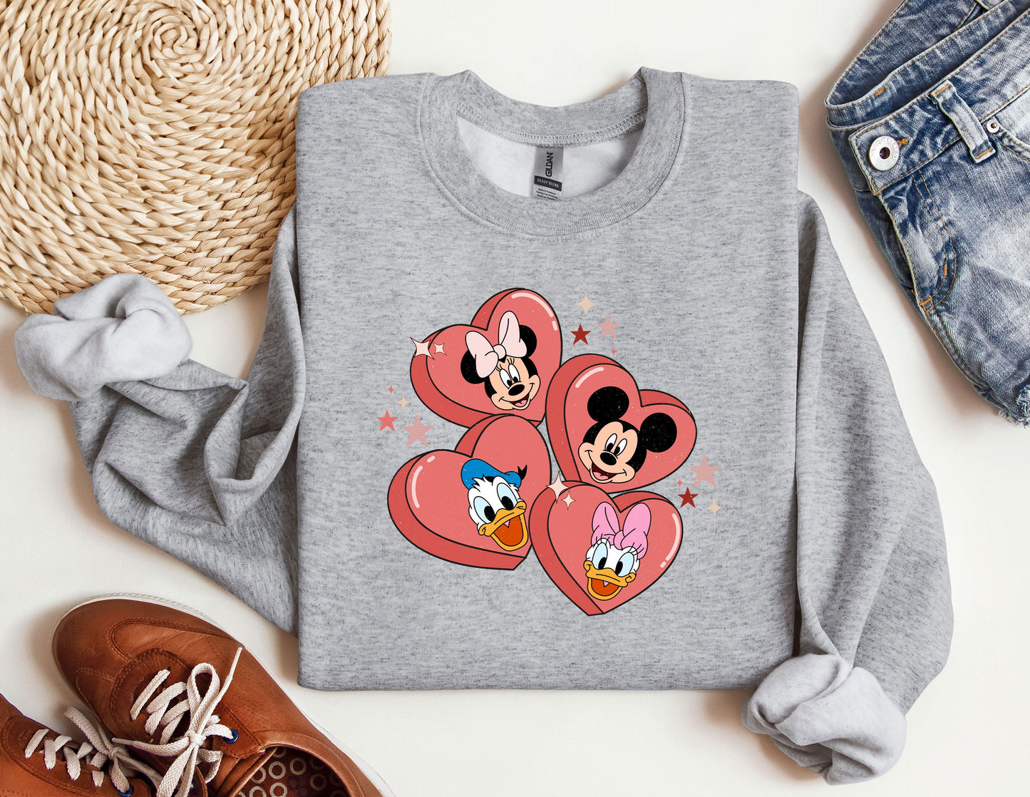 a pair of mickey and minnie mouse hearts on a sweatshirt