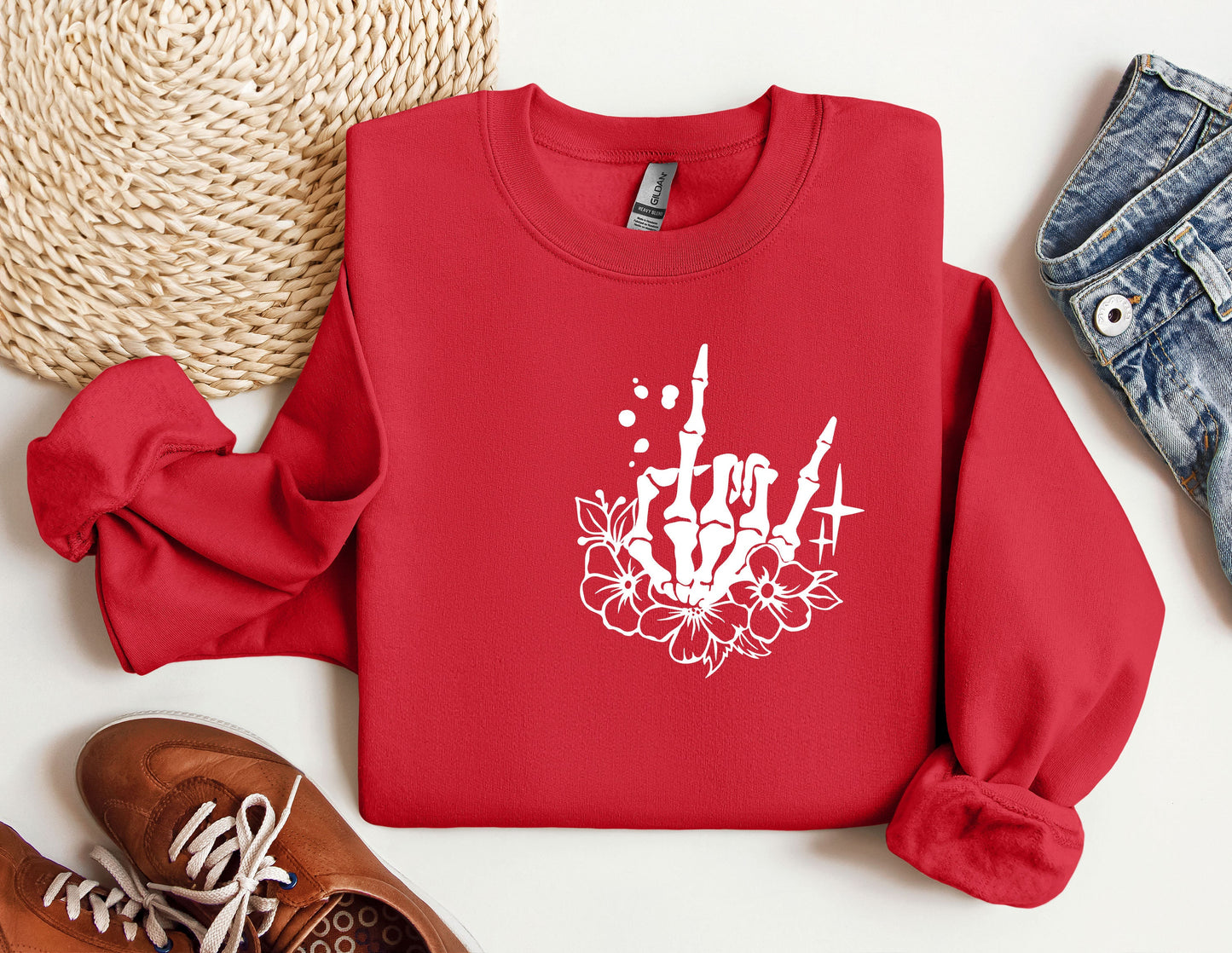 a red sweatshirt with a white flower on it