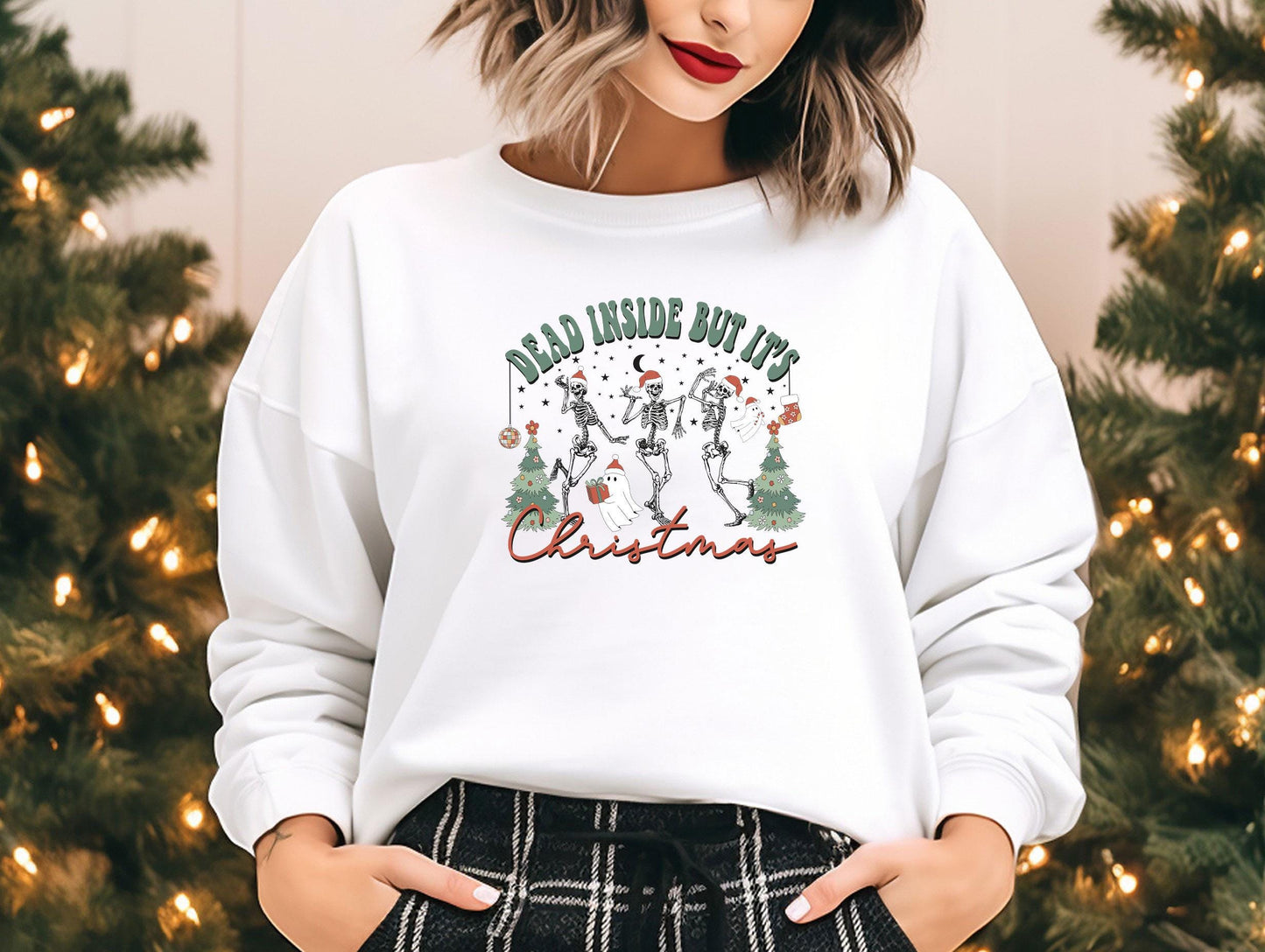 a woman standing in front of a christmas tree