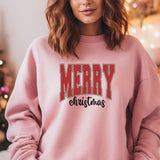 a woman wearing a pink merry christmas sweatshirt