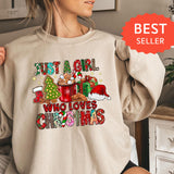 a woman wearing a sweatshirt that says, but a girl who loves christmas