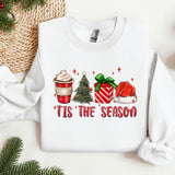 a white sweater with a christmas themed design on it