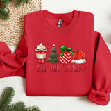 a red sweater with a christmas scene on it