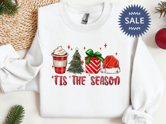 a white sweater with a christmas tree and presents on it