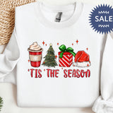 a white sweater with a christmas tree and presents on it