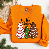 an orange shirt with a christmas tree and two trees on it
