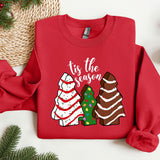 a red sweater with a christmas tree and three trees on it