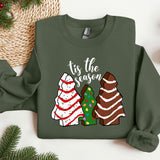 a green sweater with a christmas tree and three sweaters on it