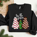 a black shirt with a christmas tree and three sweaters on it
