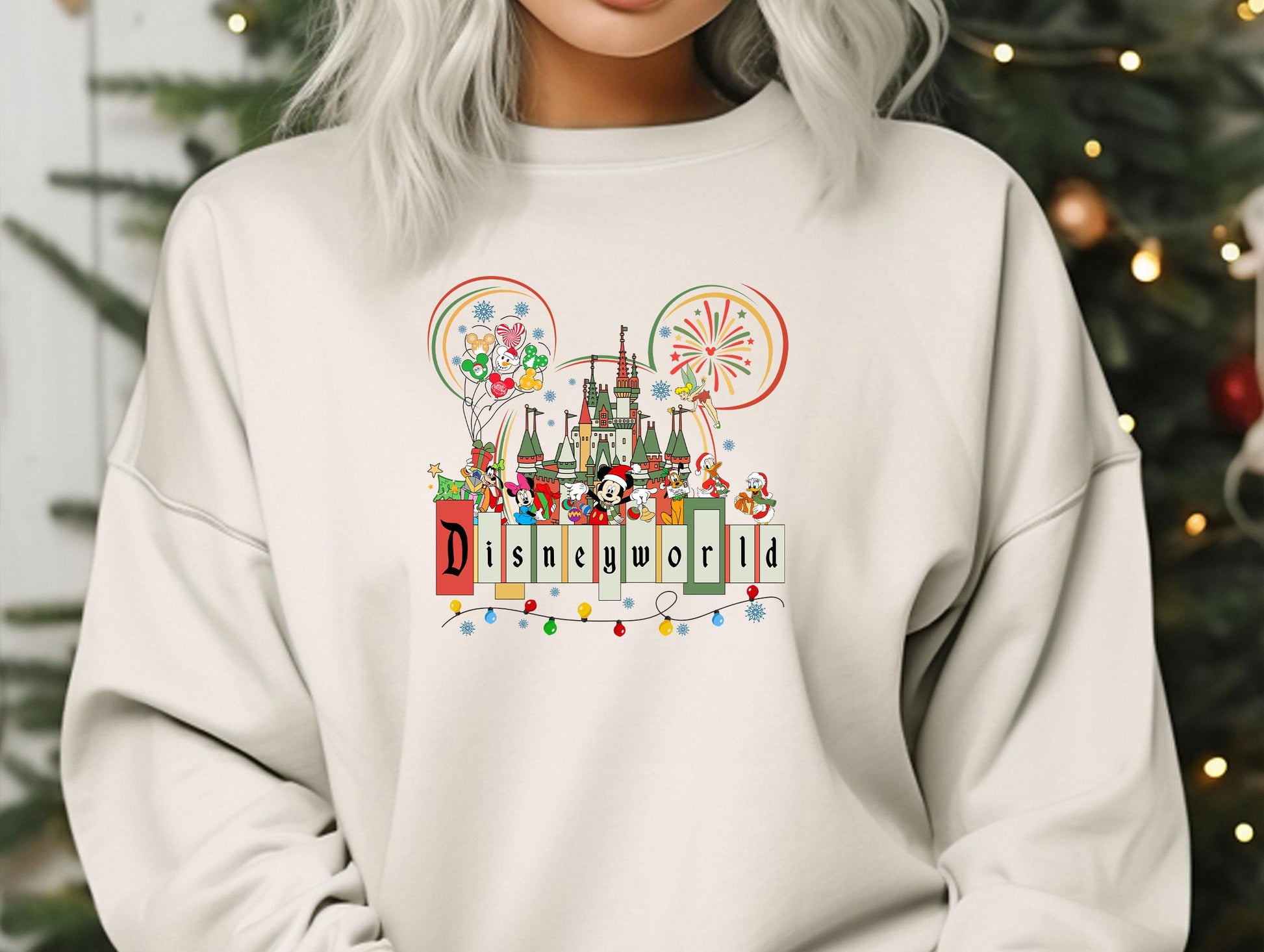 a woman wearing a white sweatshirt with a disneyland castle on it