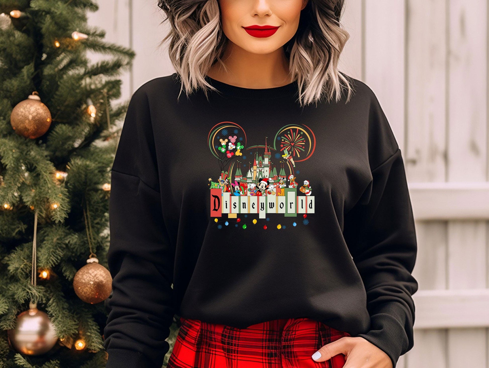 a woman wearing a mickey mouse christmas sweater