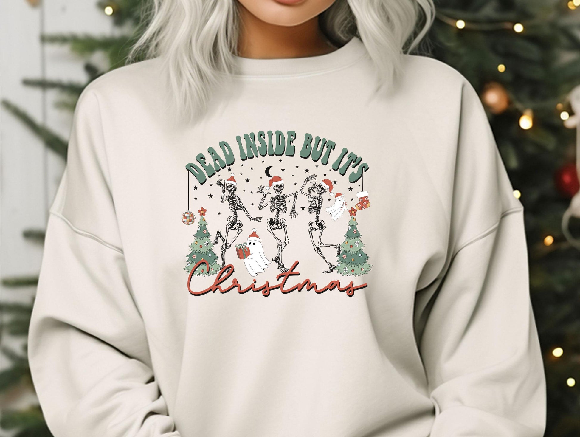 a woman wearing a sweatshirt that says dead inside butts christmas