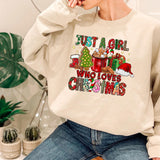 a woman sitting on a chair wearing a sweatshirt that says just a girl who loves