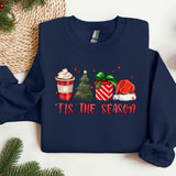 a christmas sweater with a cup of coffee and a christmas tree